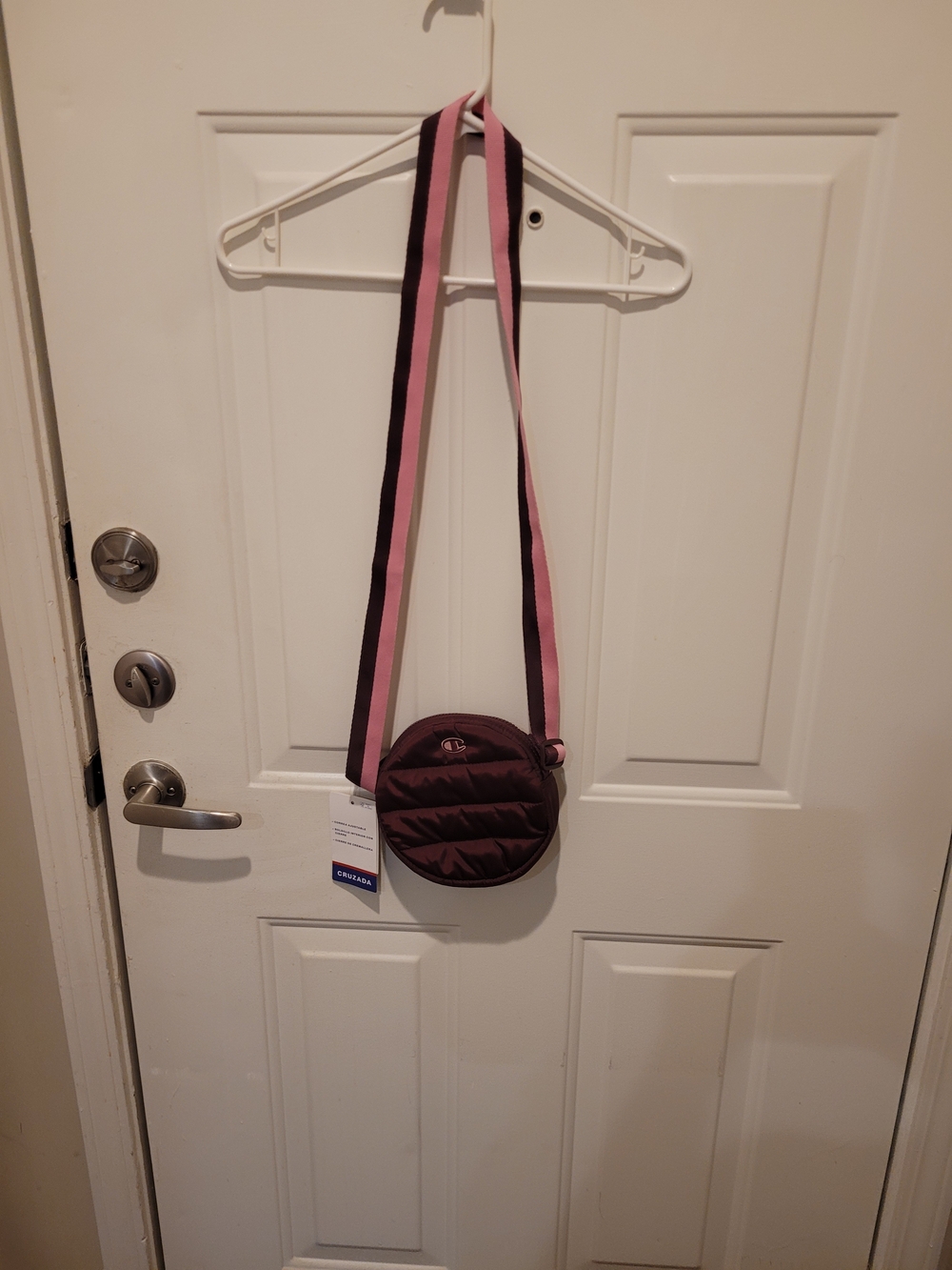 Quilted Round Crossbody Bag in Deep Plum with Pink Strap.